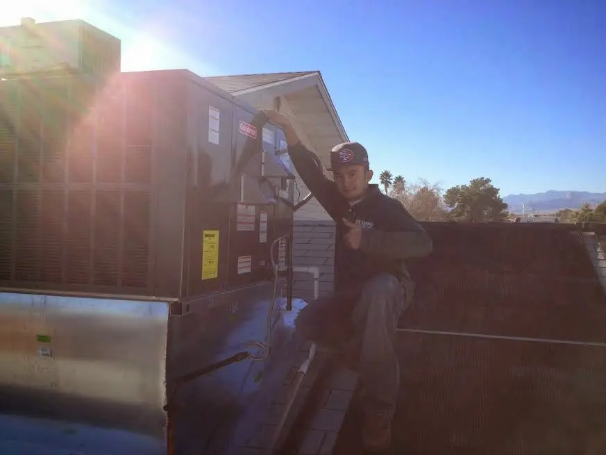 HVAC technician performing AC Tune-Up on a rooftop unit in Alcoa